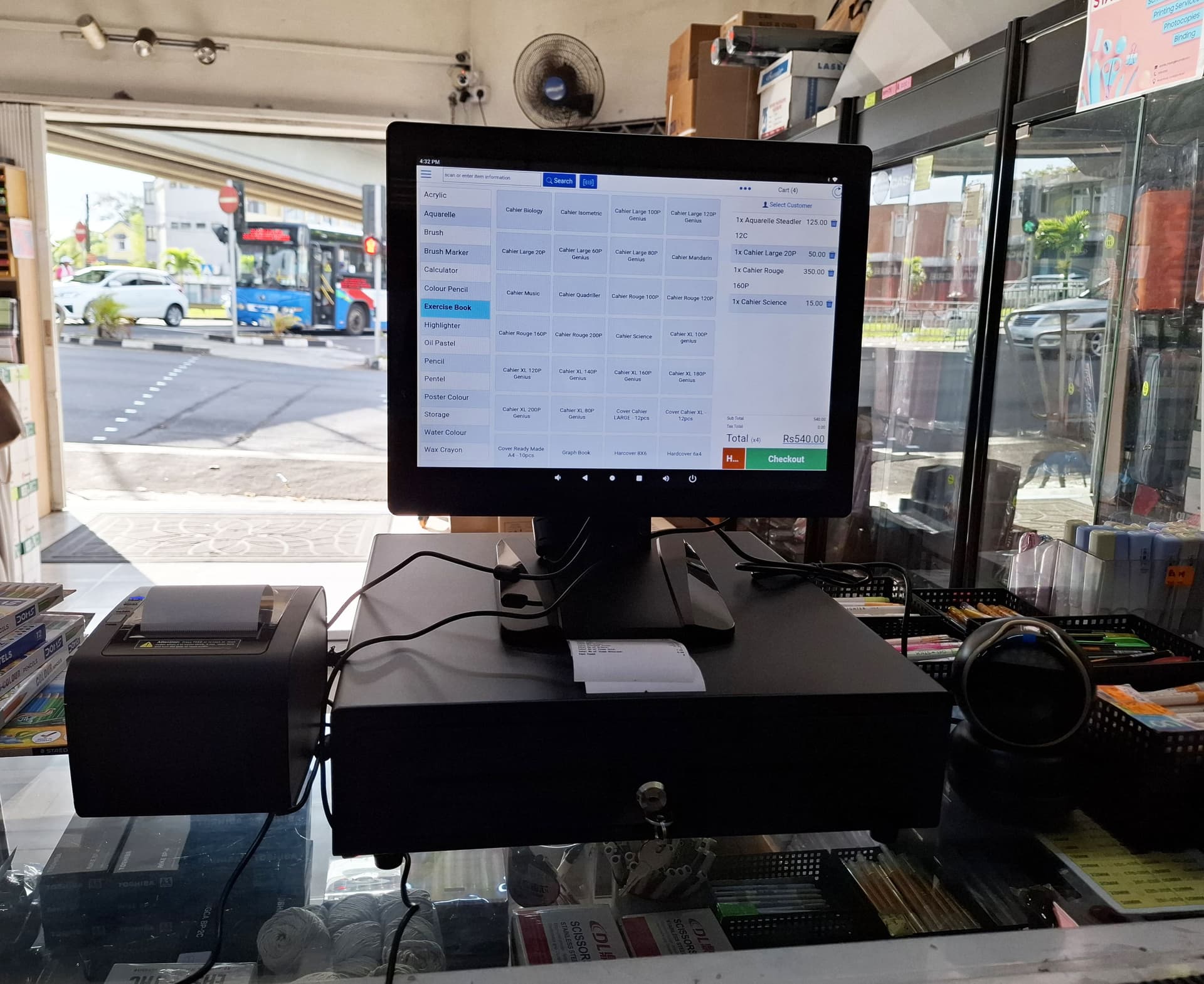 Posterita POS hardware setup — terminal, scanner, and receipt printer on a retail counter